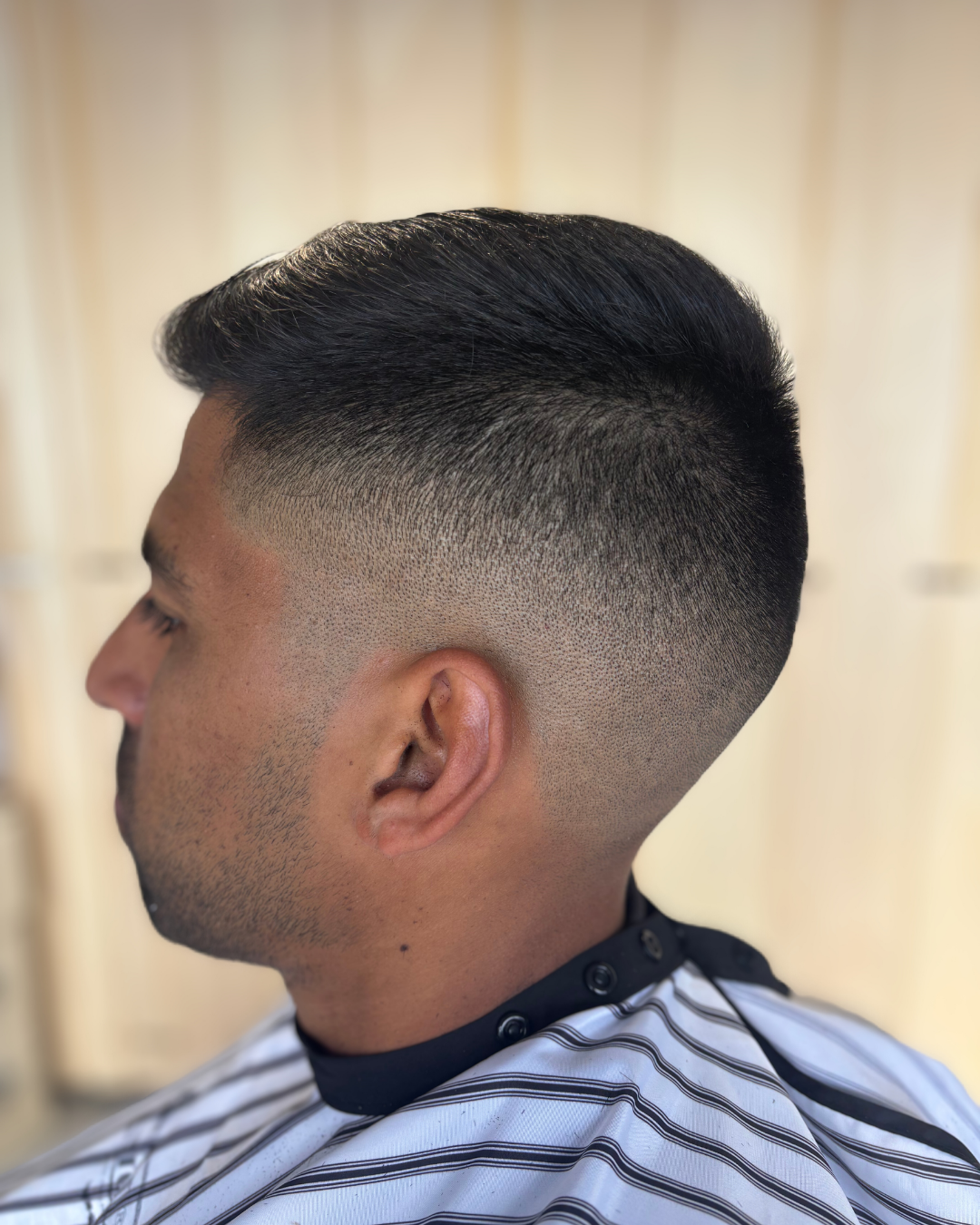 A crisp mid skin fade cut at Signature Barbershop